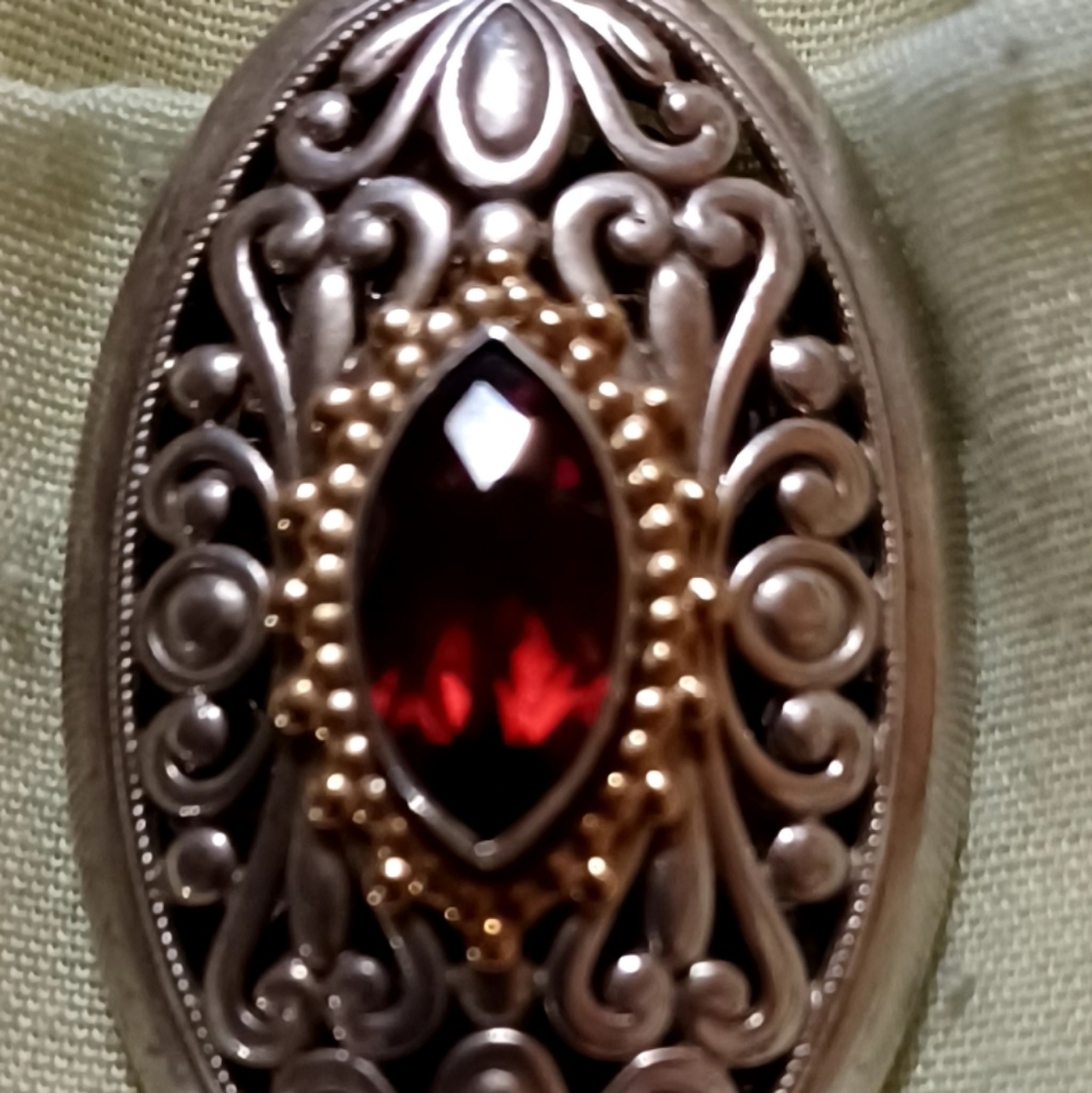 Sterling silver necklace with red garnet. Has 14k gold in a filigree design.